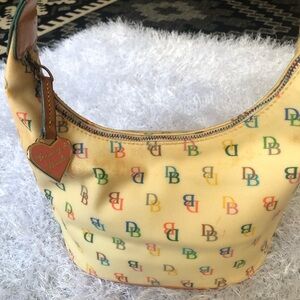 DOONEY AND BOURKE Cream colored multi colored lettering Shoulder bag
